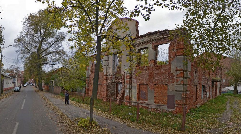 A woman walks past the ruins of the Great Lubavitch Synagogue in Vitebsk, Belarus. (Courtesy of the Municipality of Vitebsk)