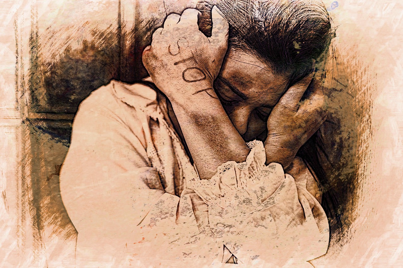 Eine Frau versteckt sich hinter ihren Armen. Auf dem Arm steht STOP